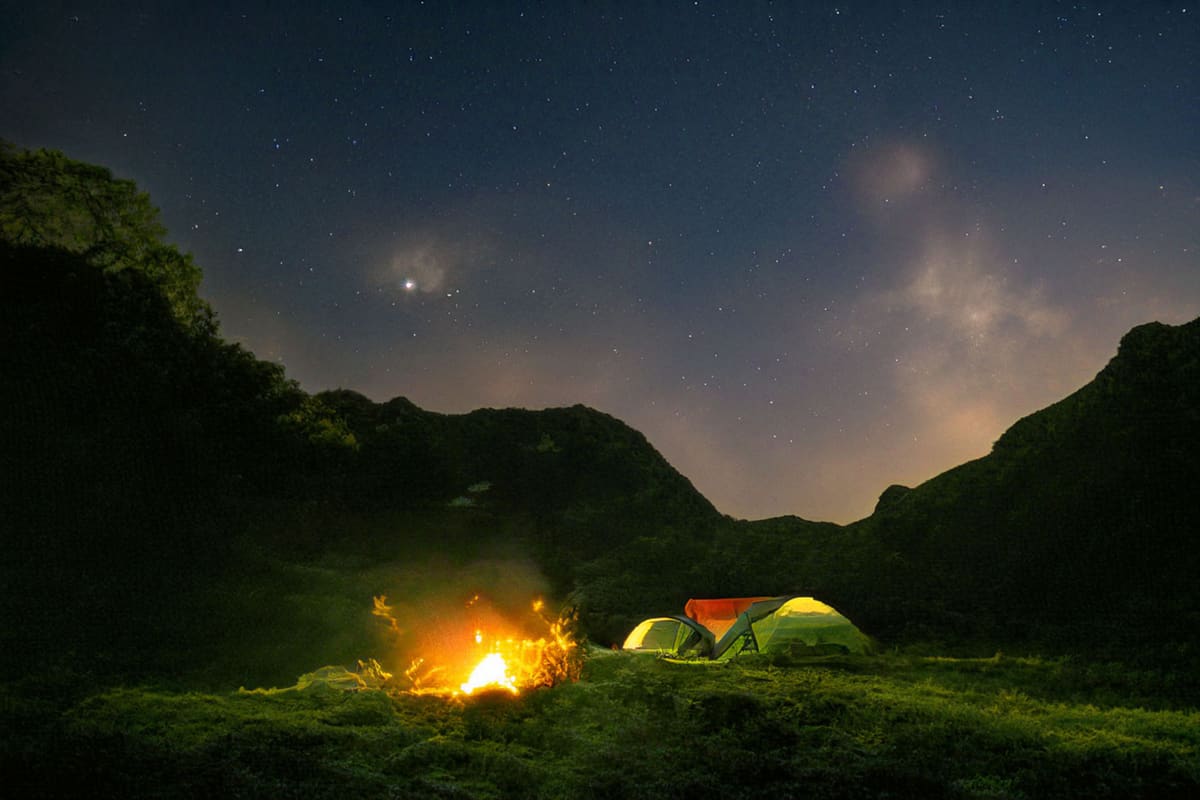 Enjoy a peaceful night camping under a starry sky with a warm bonfire.